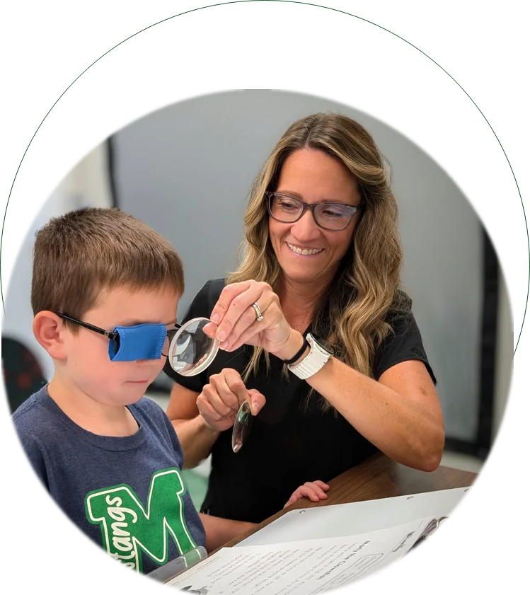 Focal Point Vision optometrist performing pediatric vision therapy with a child in Fairhope AL